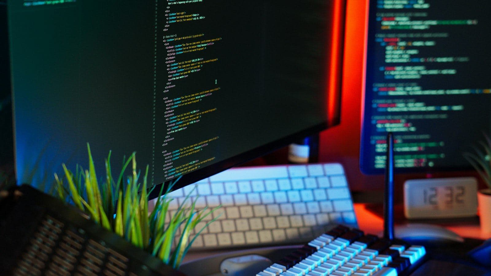 Monitors showing code and status panels